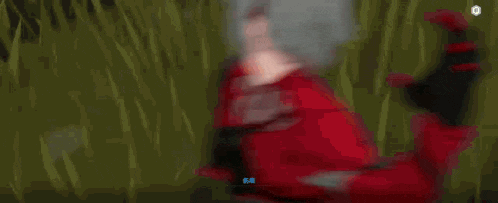 a close up of a person 's face with red eyes and a hood .