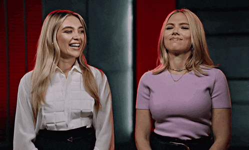 two women are standing next to each other and one is wearing a purple shirt