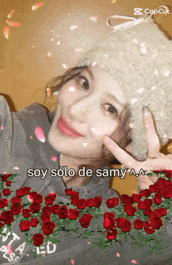 a woman is surrounded by red roses and says soy solo de samy aa