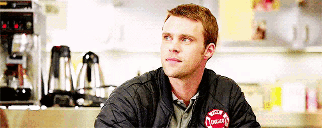 a man wearing a black jacket with the word chicago on the front