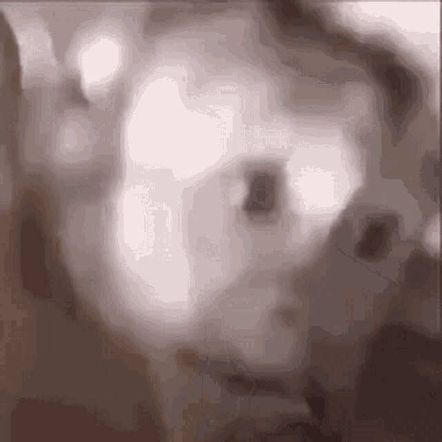 a close up of a person 's face with a blurry background