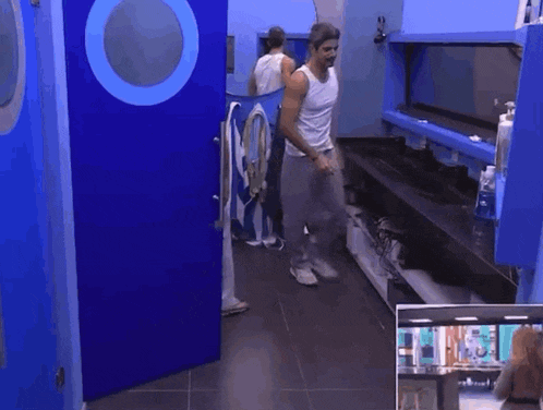 a man and a woman are dancing in a room with a blue door