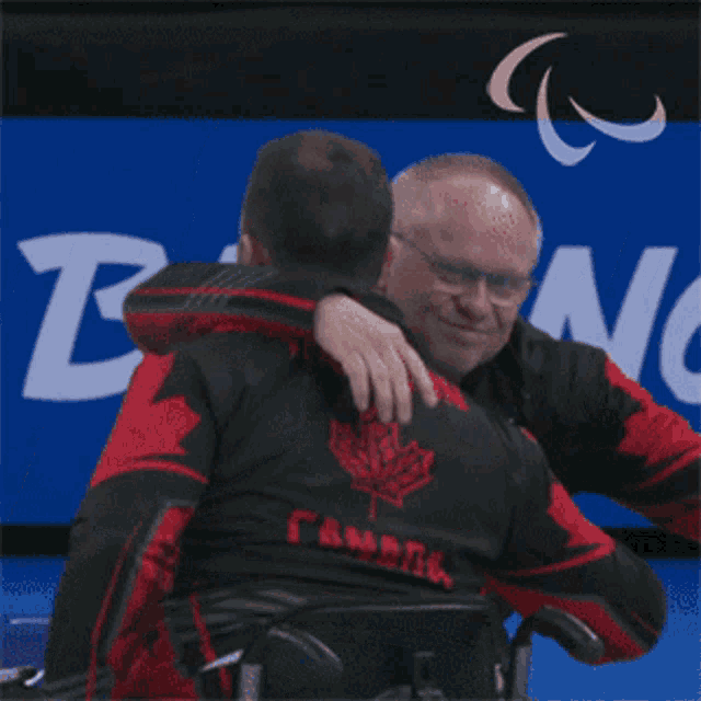 Hugging Mixed Wheelchair Curling GIF - Hugging Mixed Wheelchair Curling Canada GIFs