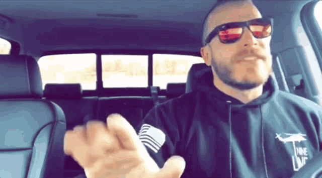 a man wearing sunglasses and a hoodie that says " i love you "