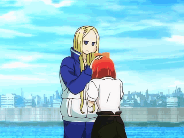 a girl with long blonde hair is standing next to another girl