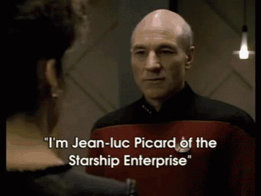 a man in a starship enterprise uniform talks to another man