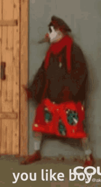 a clown is standing in front of a door with the words you like boy on the bottom