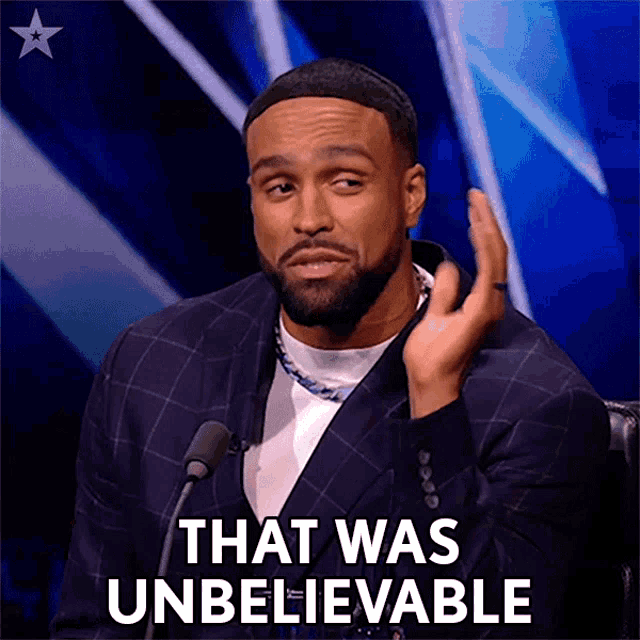 a man speaking into a microphone with the words that was unbelievable below him