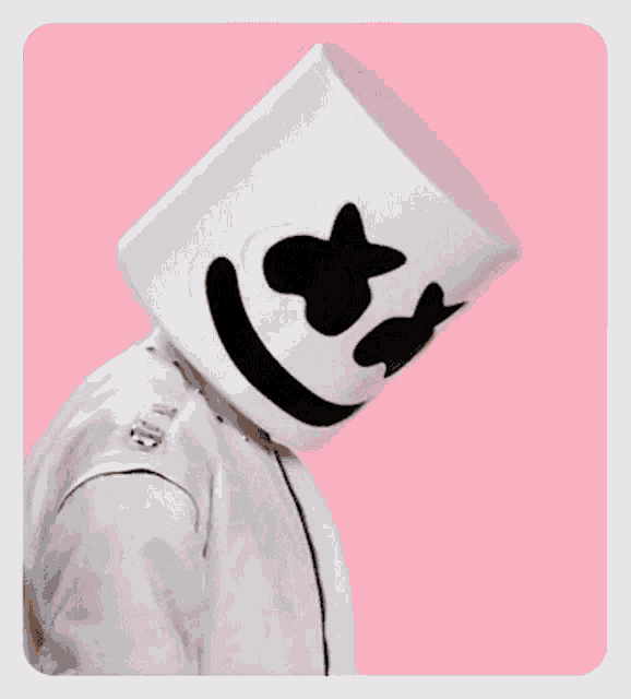a man wearing a marshmallow hat covering his face with his hands .