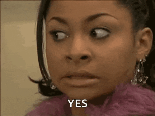 a woman in a pink coat is making a funny face and saying yes .