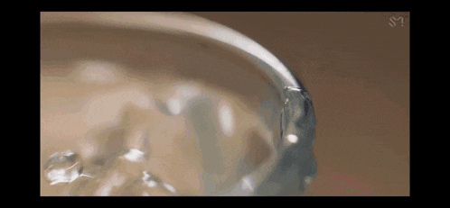 a close up of a glass of water with a watermark that says sm