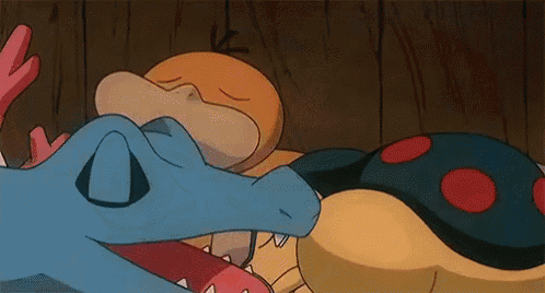 a group of cartoon characters are laying on a wooden floor .