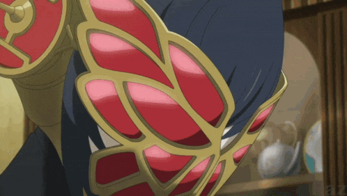a close up of a person 's arm with a red and gold design on it