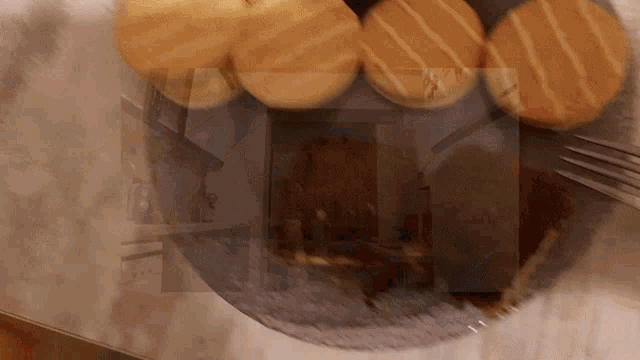 a close up of a plate of food with a blurred image of a house in the background