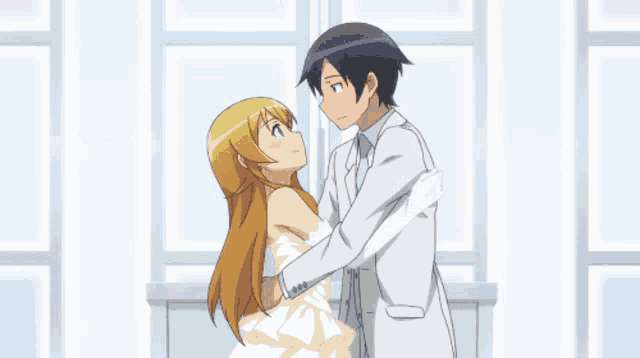 a boy and a girl are hugging and looking at each other