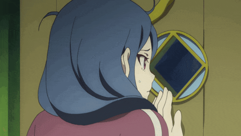 a girl with blue hair is looking through a door
