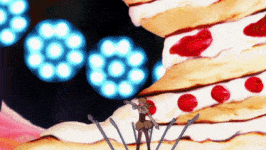 a woman is standing in front of a giant cake with red dots on it
