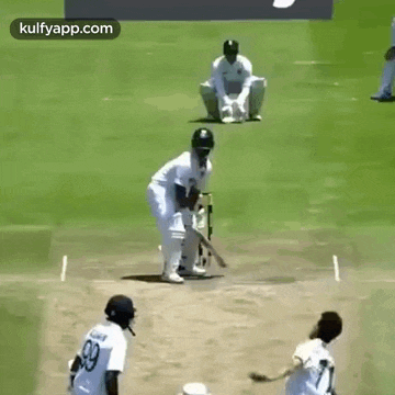 a group of cricket players are playing a game of cricket .