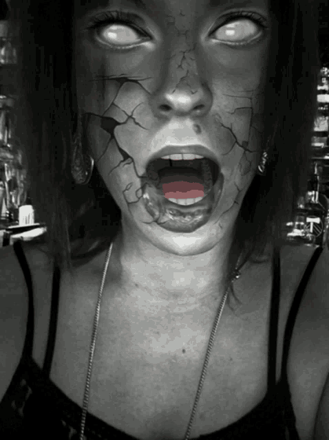 a woman with a cracked face has her mouth open