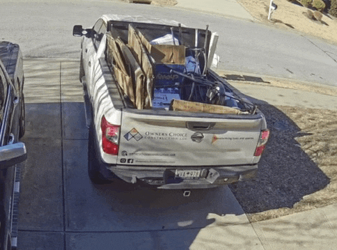 a white truck with owners choice written on the back is parked in a driveway