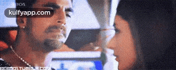 a man and a woman are looking at each other in a blurry picture .