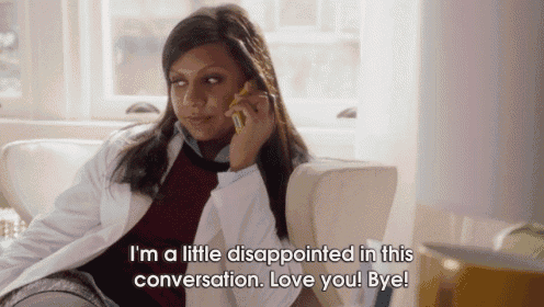 a woman in a lab coat is sitting on a couch talking on a phone