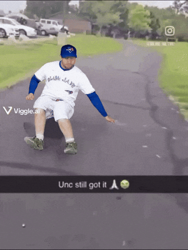 a man wearing a blue jays shirt is sliding down a road