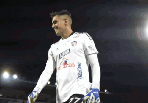 a soccer player wearing a white jersey with aguila on the front