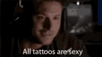 a man is wearing headphones and says `` all tattoos are sexy ''