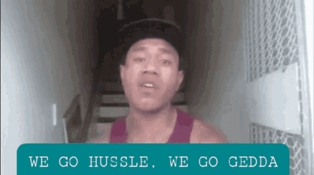 a man wearing a hat says we go hussle