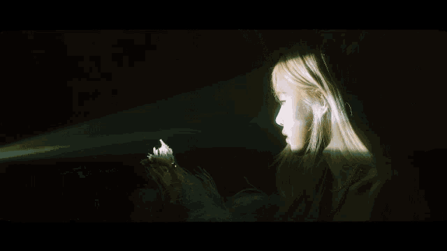 a close up of a woman with long blonde hair