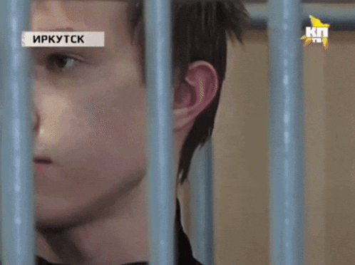 a man in a jail cell with a kn tv logo on the bottom right