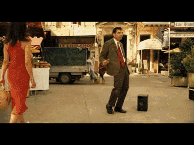 a man in a suit and tie is dancing in front of a chicken shop