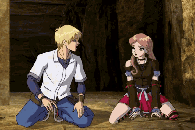 a boy and a girl are kneeling on the ground in a cave