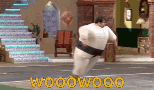 a man in a sumo suit is jumping in the air with the words wooowooo written in yellow