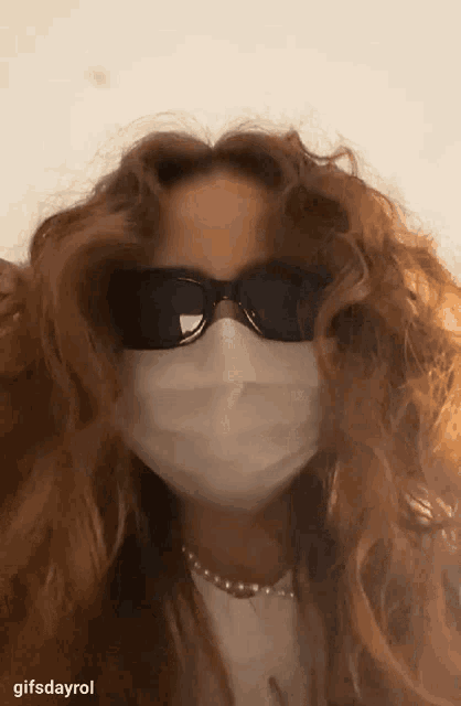 a woman wearing sunglasses and a face mask with the caption gifsdayrol