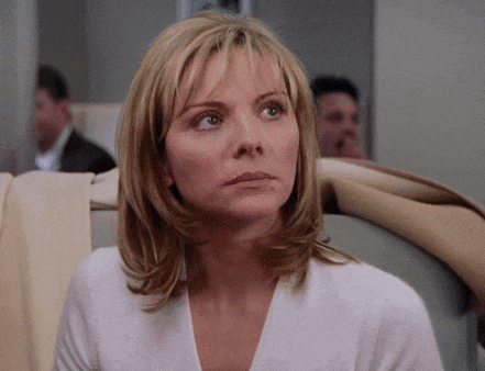 a woman with blonde hair and a white shirt is sitting on a plane