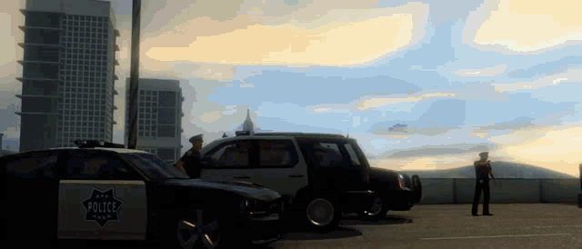 two police officers are standing in front of a police car