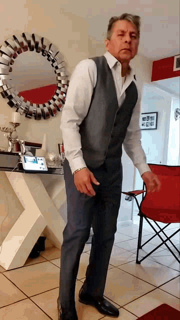 a man in a suit is standing in front of a round mirror