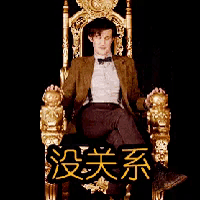 a man in a suit and bow tie is sitting on a gold throne