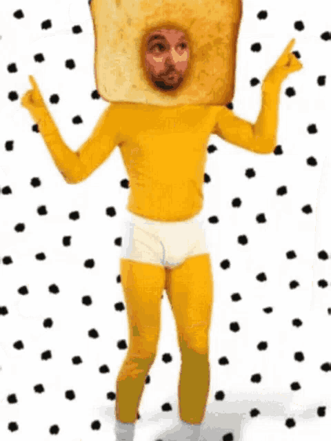 a man is wearing a yellow shirt and underwear with a piece of toast on his head .