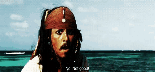 jack sparrow from pirates of the caribbean is standing in front of the ocean .