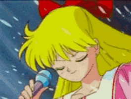 a girl with a red bow on her head singing into a microphone