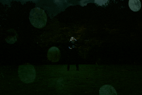 a person standing in a field with a shirt that says ' slender man ' on it
