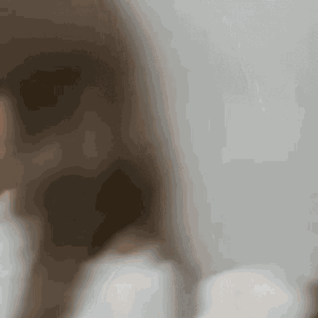 a blurry picture of a woman 's face against a white background .