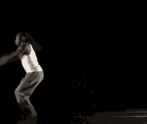 a man is doing a handstand on the floor in the dark