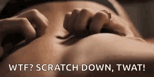 a woman is scratching her belly with her hands while laying down .