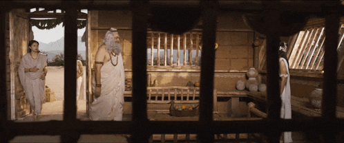 a man with a beard and a woman behind bars