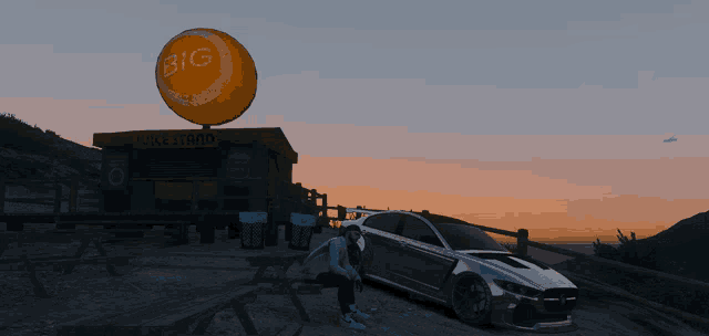 a car is parked in front of a big orange