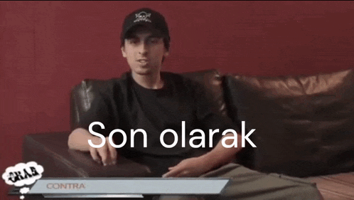 a man in a black hat is sitting on a couch with the words son olarak behind him